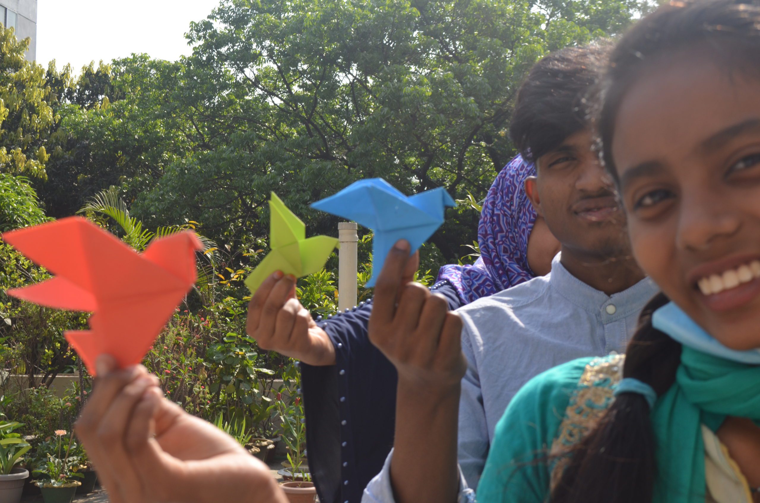 Children holding paper birds