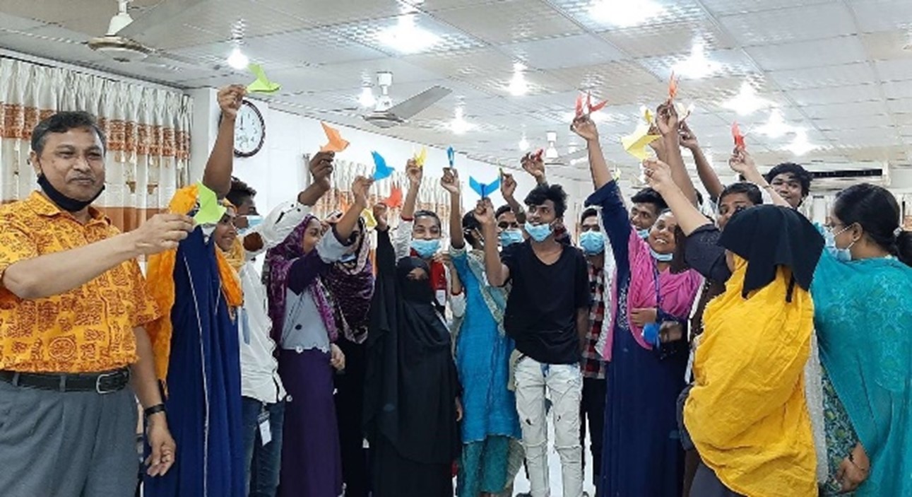 Bangladesh team holding paper birds